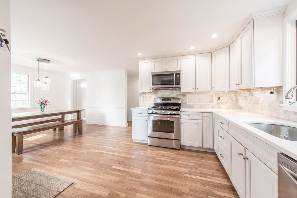 9 Legion Road Weston, MA 02493 - Photo 6 of 30 a kitchen with kitchen island white cabinets and appliances