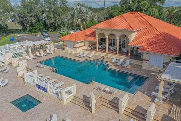 an aerial view of a house with swimming pool having outdoor seating