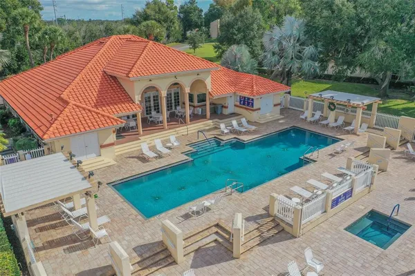 a view of a house with backyard and sitting area