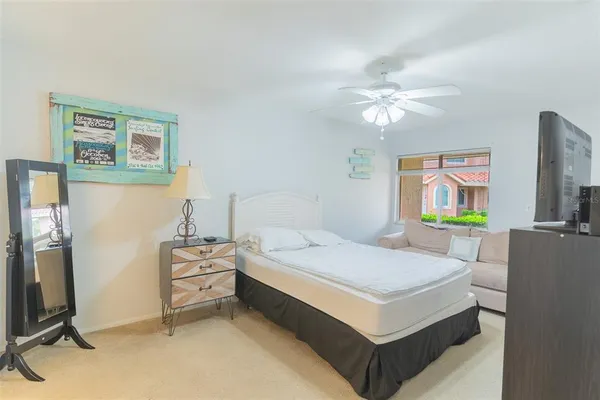 a bedroom with a bed and a flat screen tv