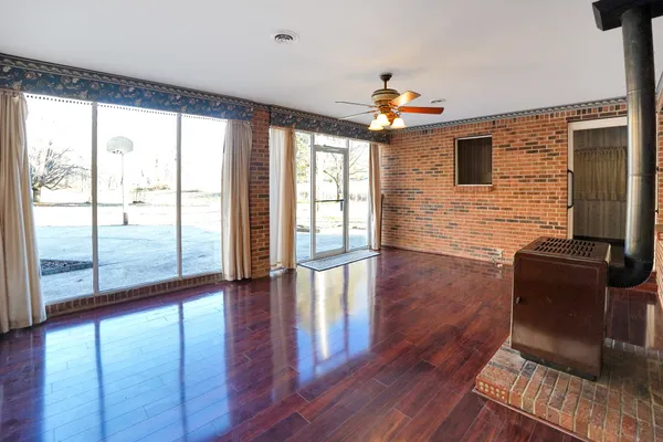 a living room with hardwood floor and a flat screen tv