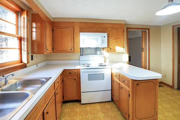 a kitchen with a sink stove and cabinets