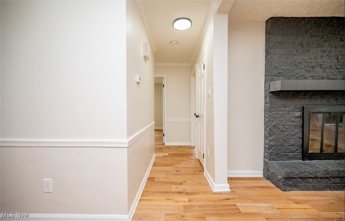 6006 Tippecanoe Road Canfield, OH 44406 - Photo 13 of 35 Hallway with wood finished floors, baseboards, and ornamental molding