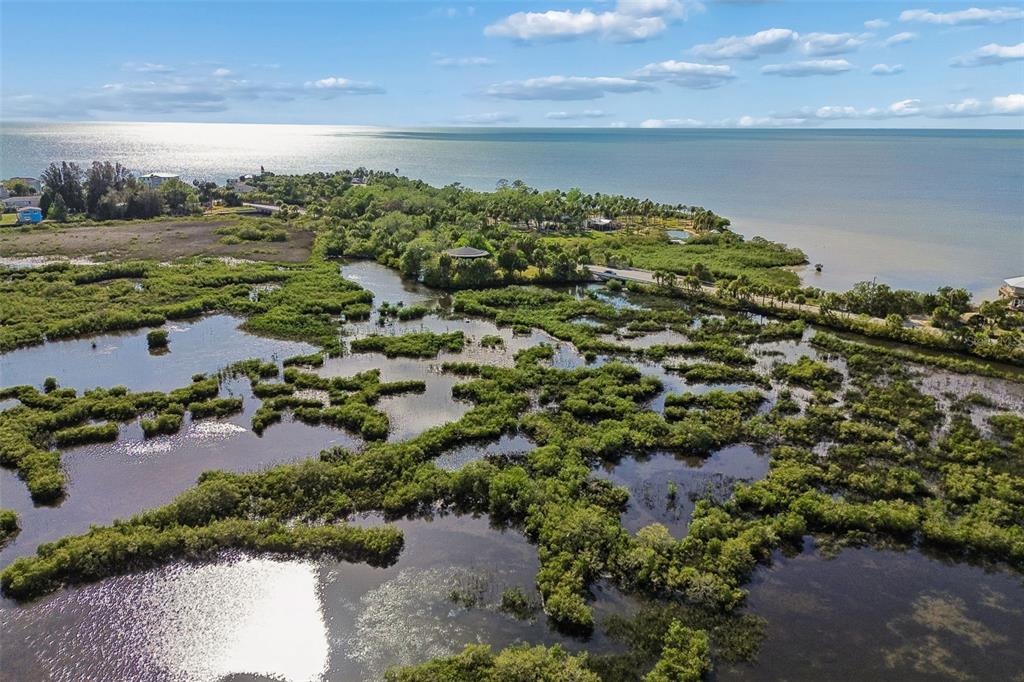 10501 Pine Island Drive Weeki Wachee, FL 34607 - Photo 13 of 54 a view of a lake with a yard