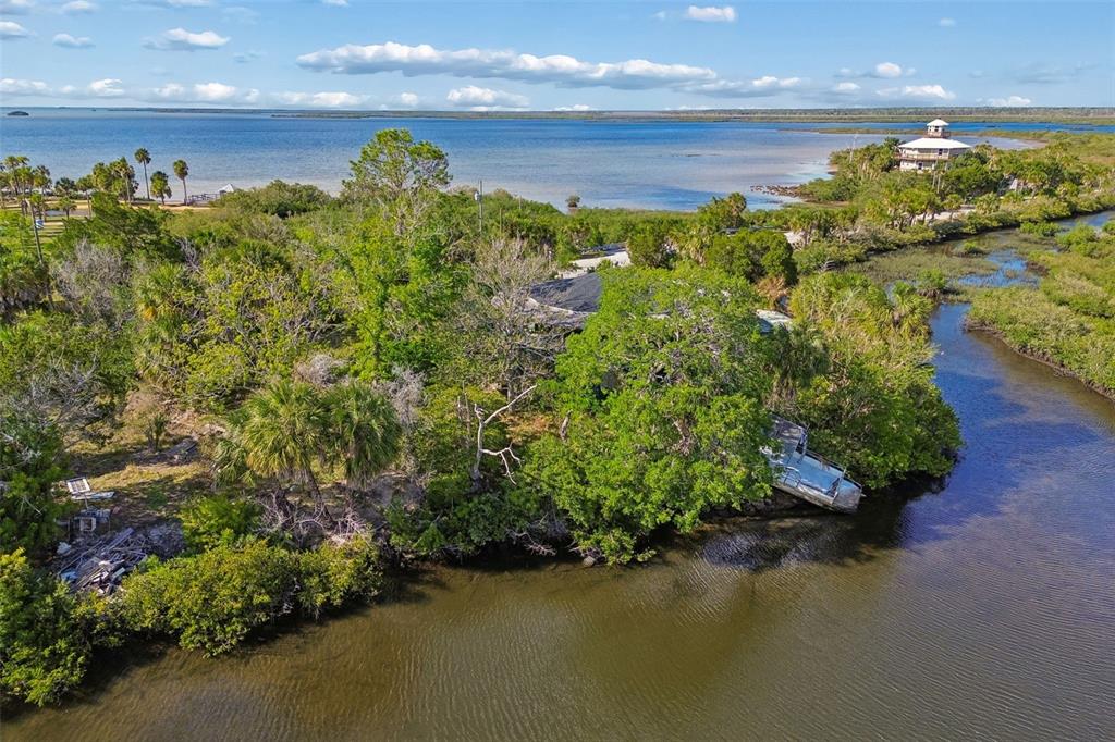 10501 Pine Island Drive Weeki Wachee, FL 34607 - Photo 27 of 54 a view of a lake with a building in the background