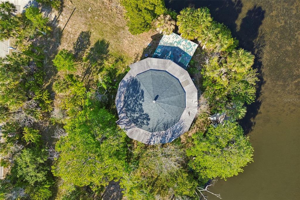 10501 Pine Island Drive Weeki Wachee, FL 34607 - Photo 33 of 54 a aerial view of a house with a yard and garden
