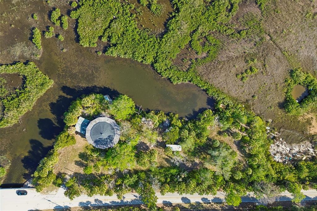 10501 Pine Island Drive Weeki Wachee, FL 34607 - Photo 34 of 54 an aerial view of a house with a yard and swimming pool