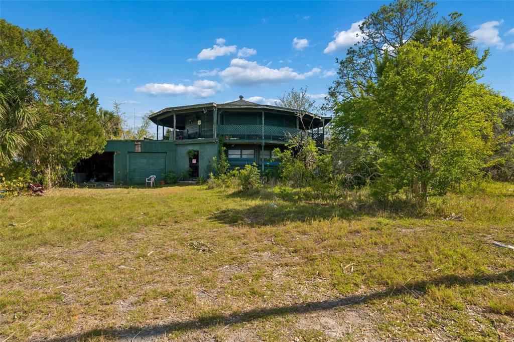 10501 Pine Island Drive Weeki Wachee, FL 34607 - Photo 49 of 54 a front view of a house with a yard