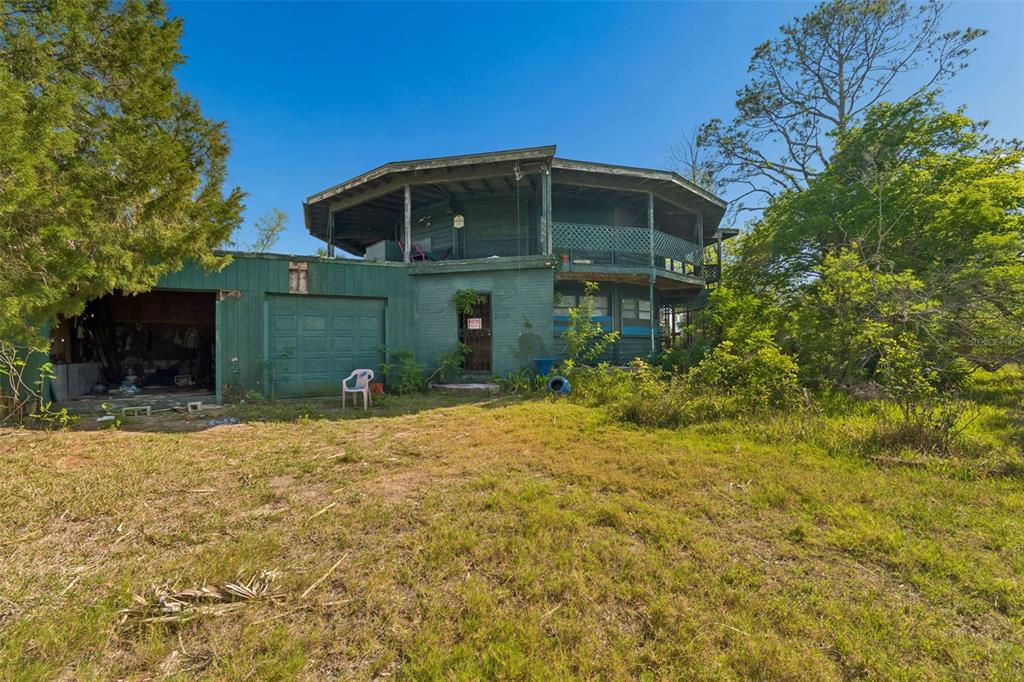 10501 Pine Island Drive Weeki Wachee, FL 34607 - Photo 50 of 54 a front view of a house with a yard