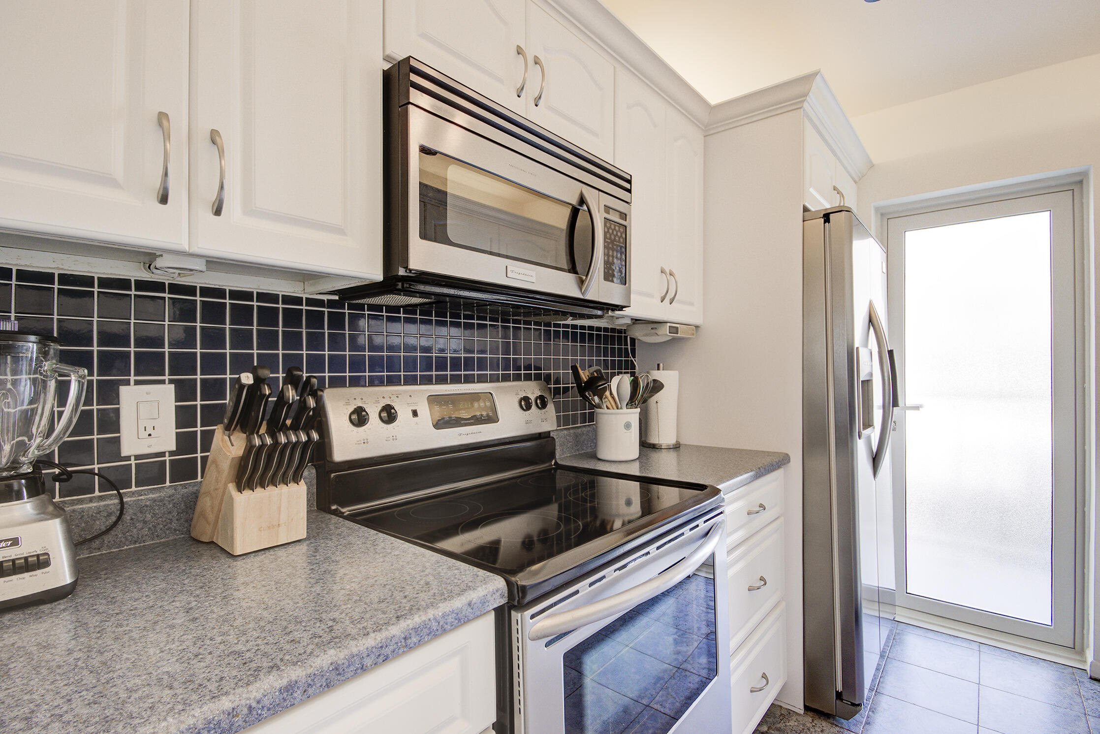 3100 South Ocean Boulevard, Unit 216 Highland Beach, FL 33487 - Photo 12 of 34 a kitchen with a stove and a microwave