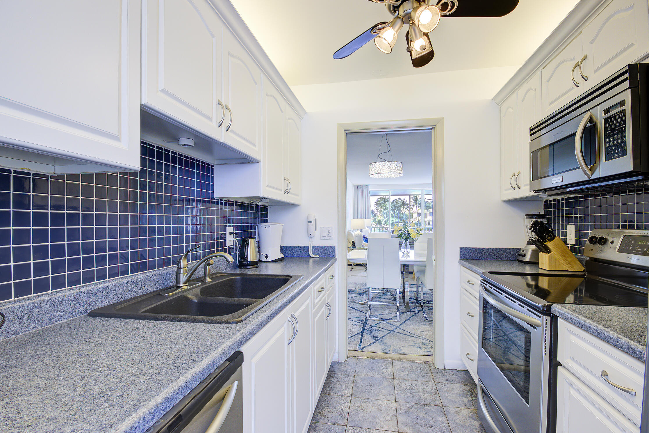 3100 South Ocean Boulevard, Unit 216 Highland Beach, FL 33487 - Photo 13 of 34 a kitchen with a sink and cabinets