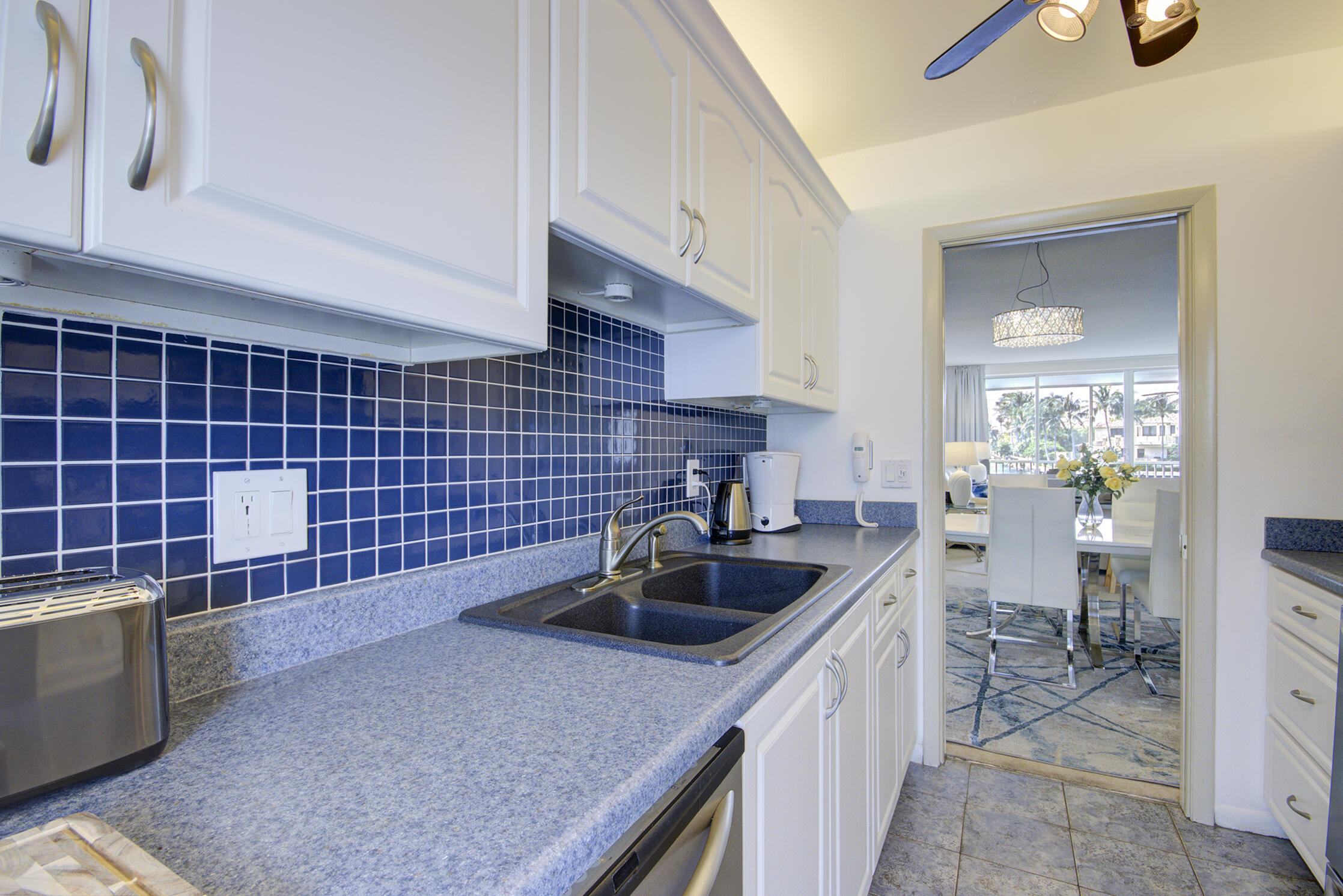 3100 South Ocean Boulevard, Unit 216 Highland Beach, FL 33487 - Photo 14 of 34 a kitchen with a sink and cabinets