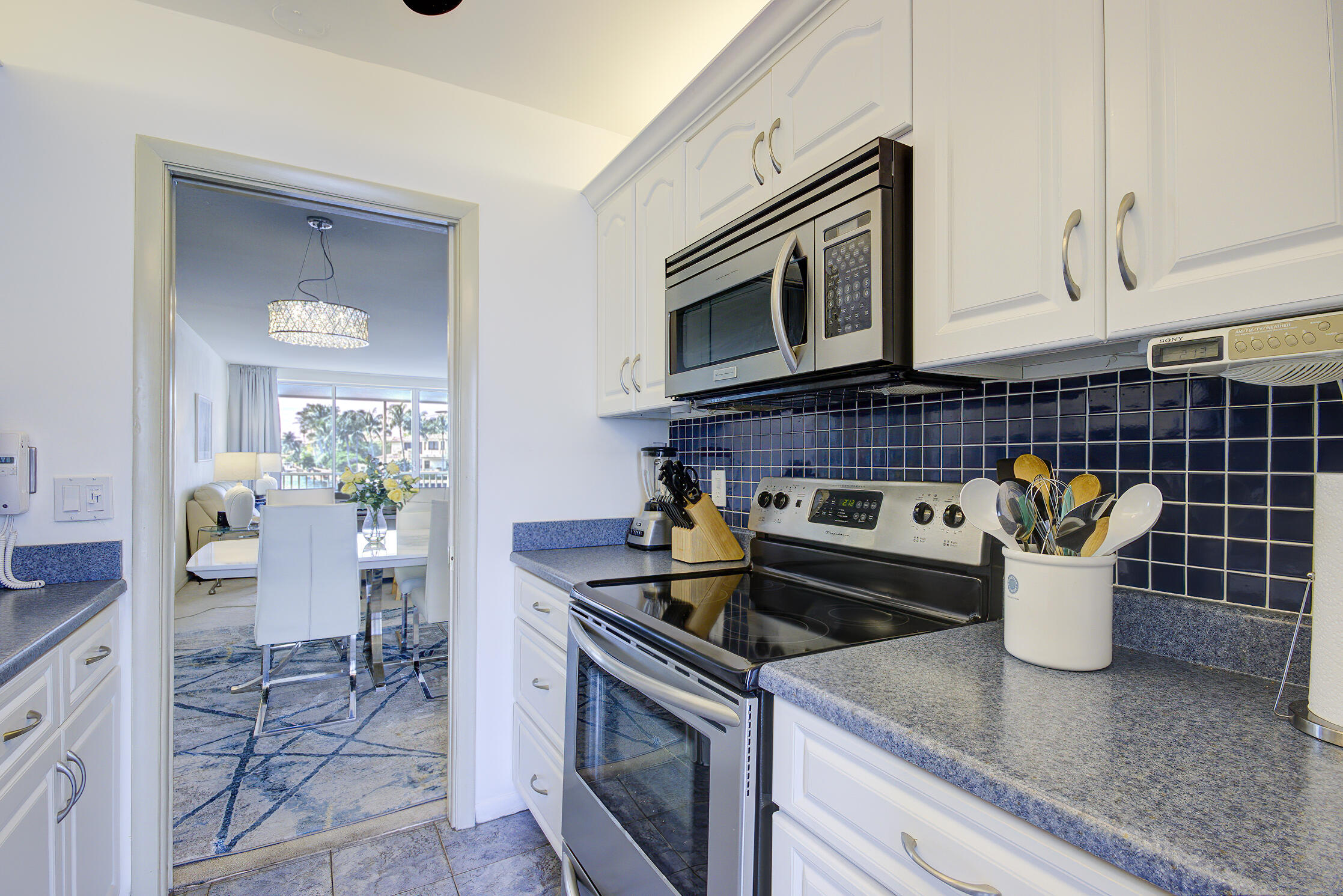 3100 South Ocean Boulevard, Unit 216 Highland Beach, FL 33487 - Photo 15 of 34 a kitchen with a stove microwave and cabinets