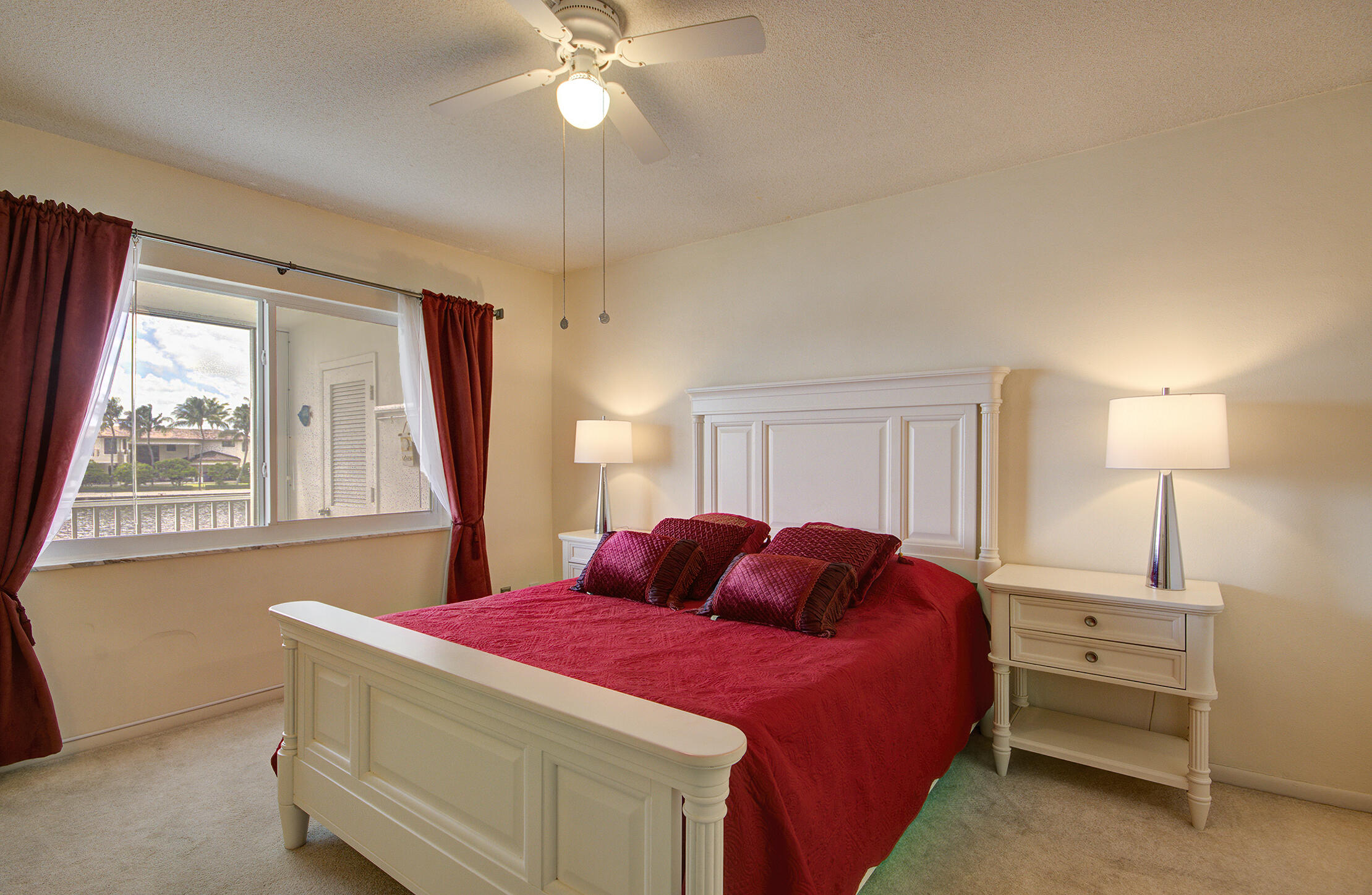3100 South Ocean Boulevard, Unit 216 Highland Beach, FL 33487 - Photo 17 of 34 a bed room with a bed and a chandelier