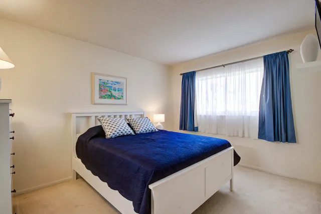 a bed room with a bed and a dresser