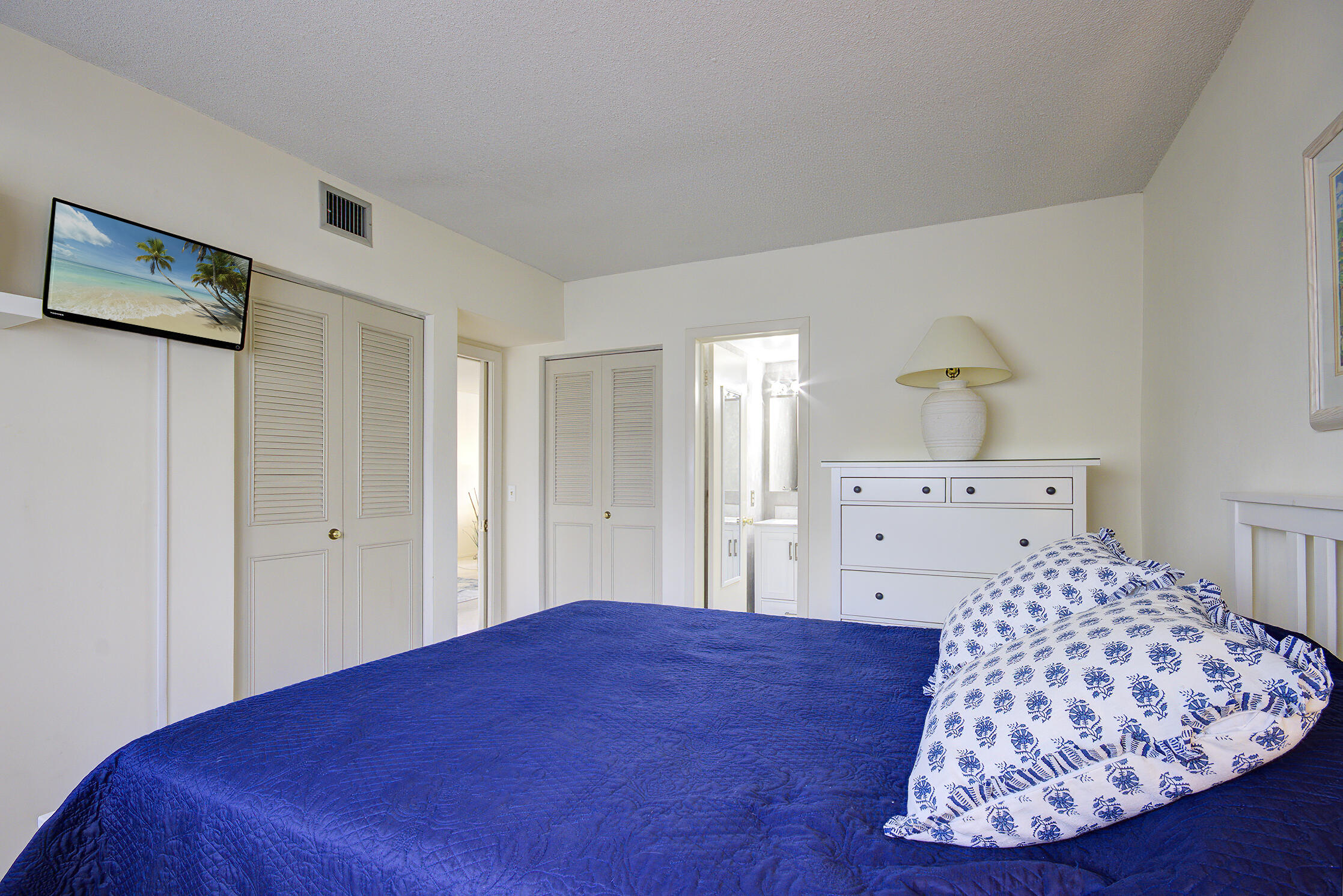 3100 South Ocean Boulevard, Unit 216 Highland Beach, FL 33487 - Photo 21 of 34 a bedroom with a bed and a dresser