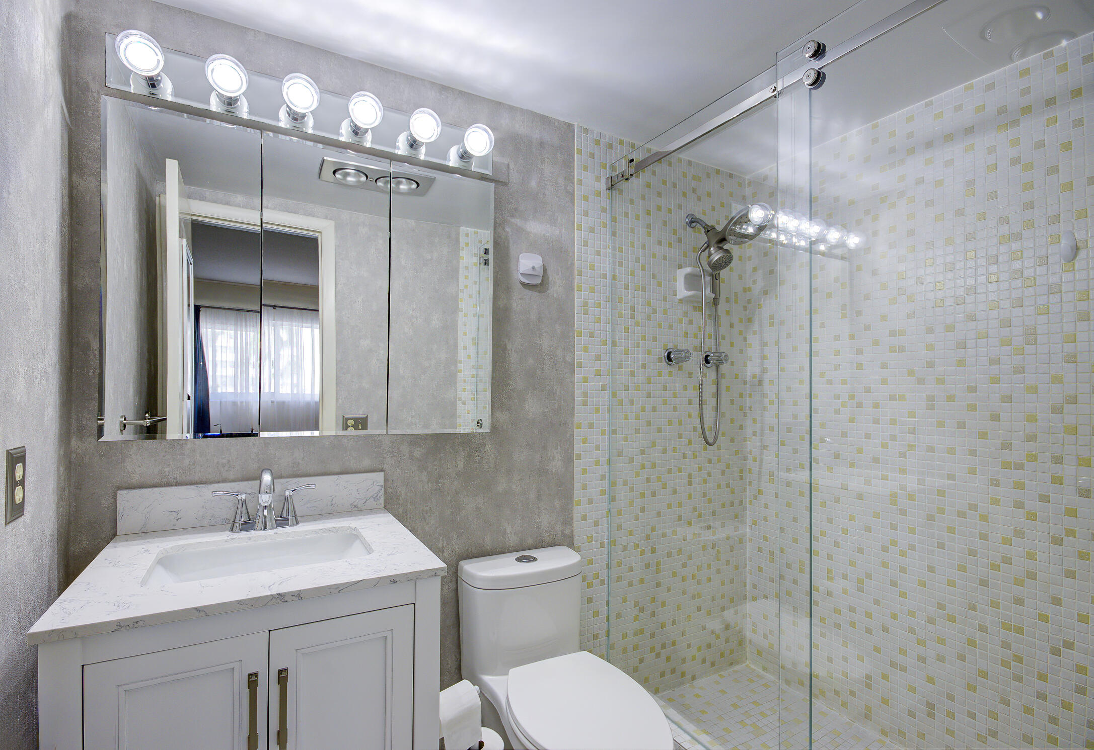 3100 South Ocean Boulevard, Unit 216 Highland Beach, FL 33487 - Photo 22 of 34 a bathroom with a sink a toilet a mirror and shower