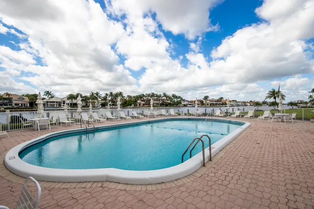 a view of a swimming pool with outdoor seating