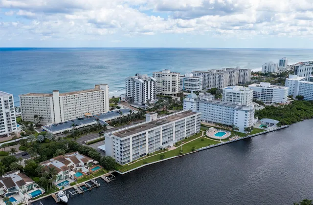 a aerial view of a residential apartment building with a yard