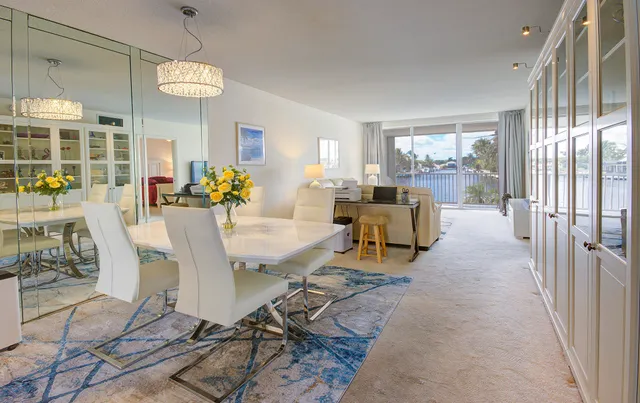 a view of a dining room with furniture a chandelier and wooden floor