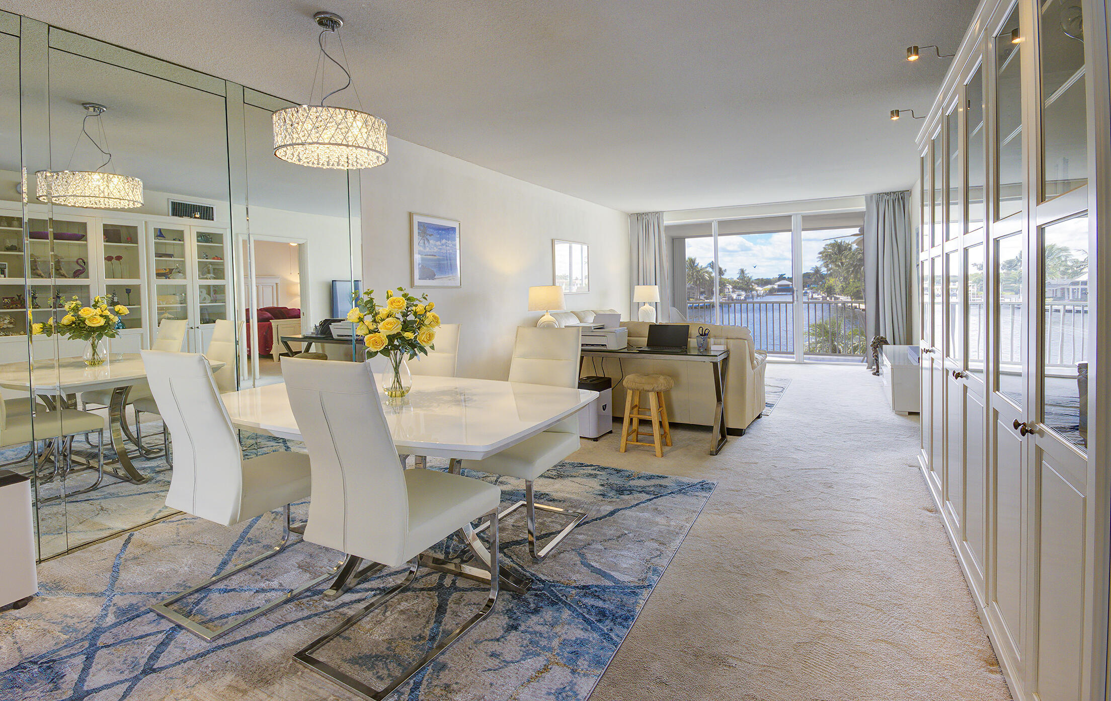 3100 South Ocean Boulevard, Unit 216 Highland Beach, FL 33487 - Photo 3 of 34 a view of a dining room with furniture a chandelier and wooden floor