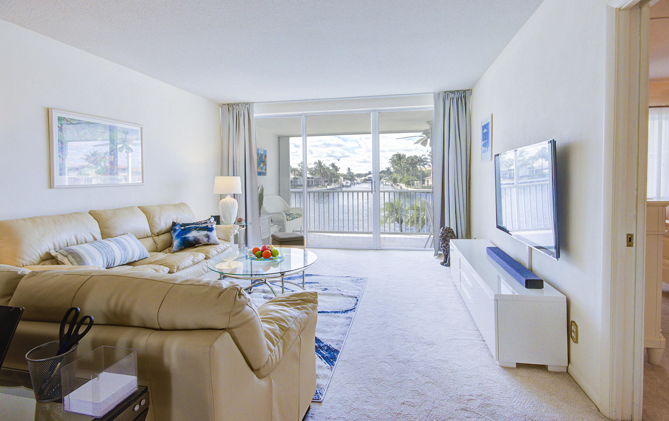 3100 South Ocean Boulevard, Unit 216 Highland Beach, FL 33487 - Photo 4 of 34 a living room with furniture and a flat screen tv