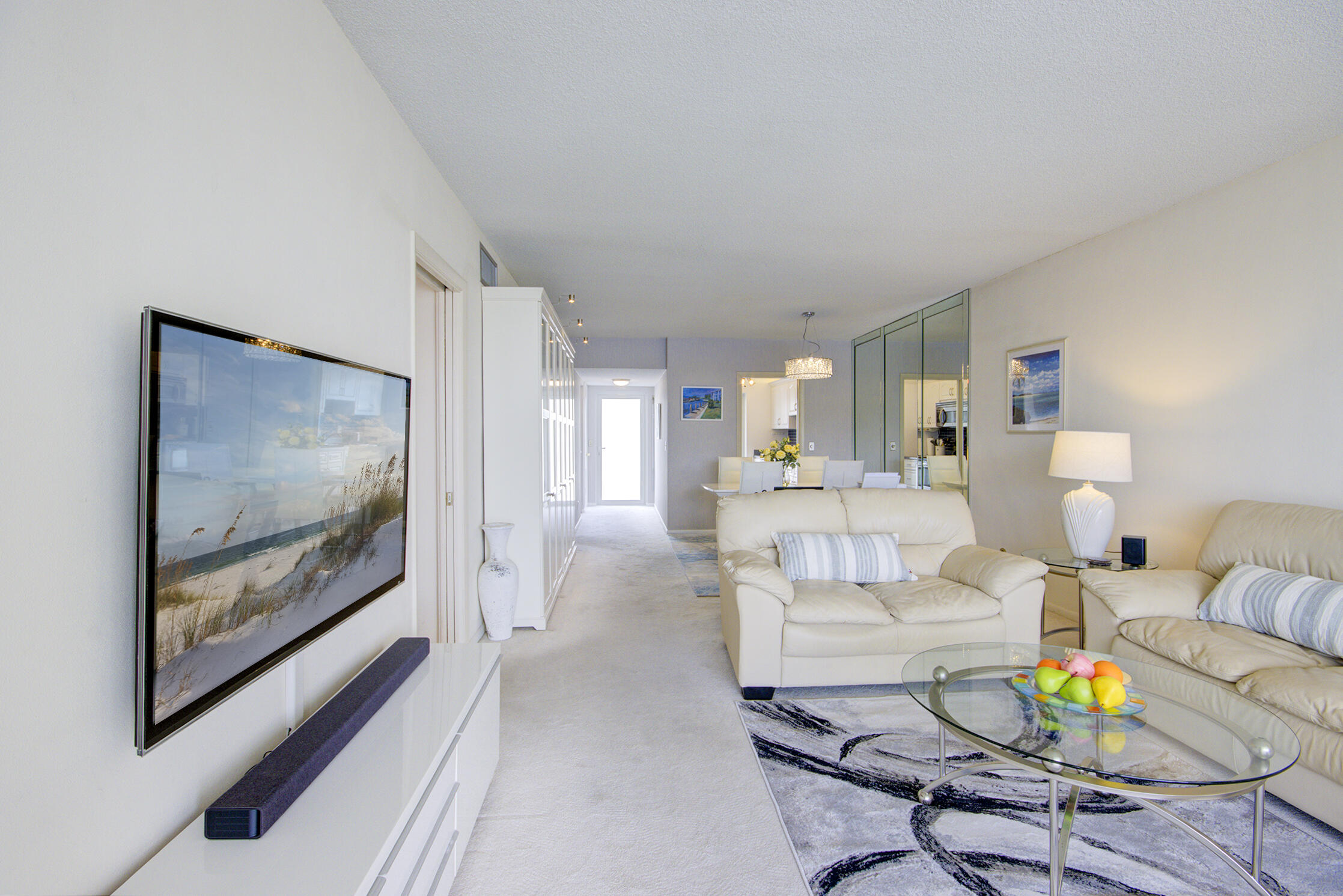3100 South Ocean Boulevard, Unit 216 Highland Beach, FL 33487 - Photo 8 of 34 a living room with furniture and a flat screen tv