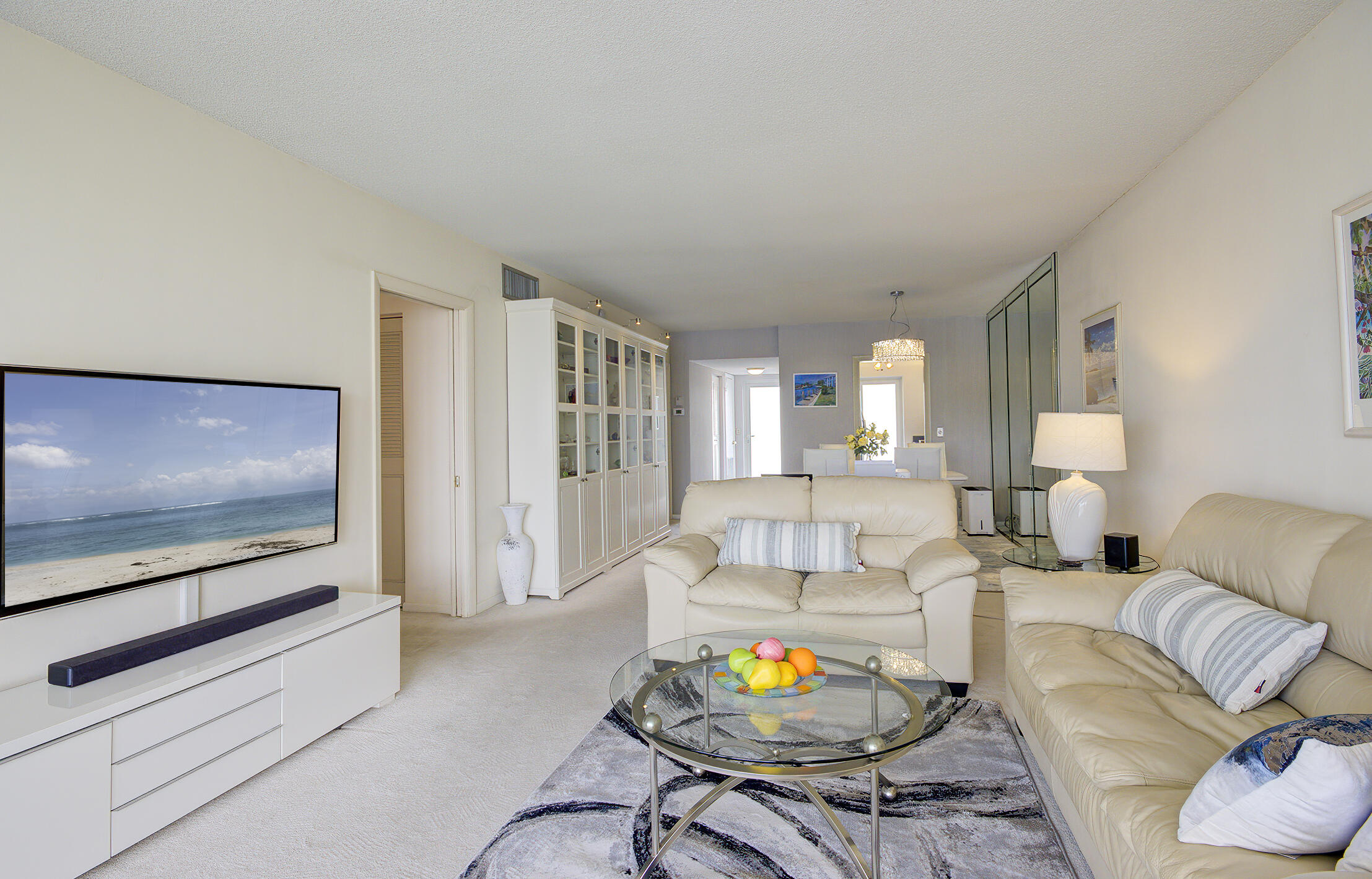 3100 South Ocean Boulevard, Unit 216 Highland Beach, FL 33487 - Photo 9 of 34 a living room with furniture and a flat screen tv