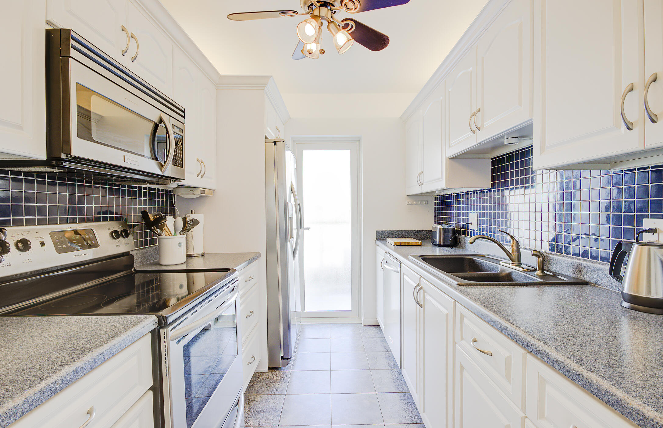 3100 South Ocean Boulevard, Unit 216 Highland Beach, FL 33487 - Photo 10 of 34 a kitchen that has a sink and a stove