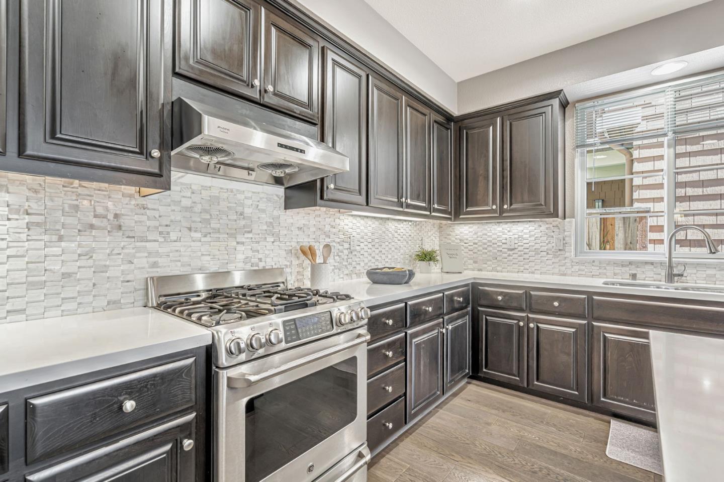 310 Villa Street Mountain View, CA 94041 - Photo 14 of 40 a kitchen with stainless steel appliances granite countertop a sink stove and cabinets
