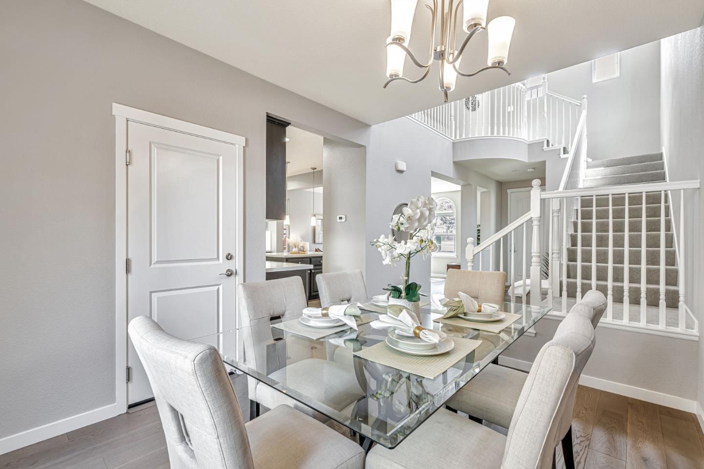 310 Villa Street Mountain View, CA 94041 - Photo 18 of 40 a dining room with wooden floor a chandelier a glass table and chairs