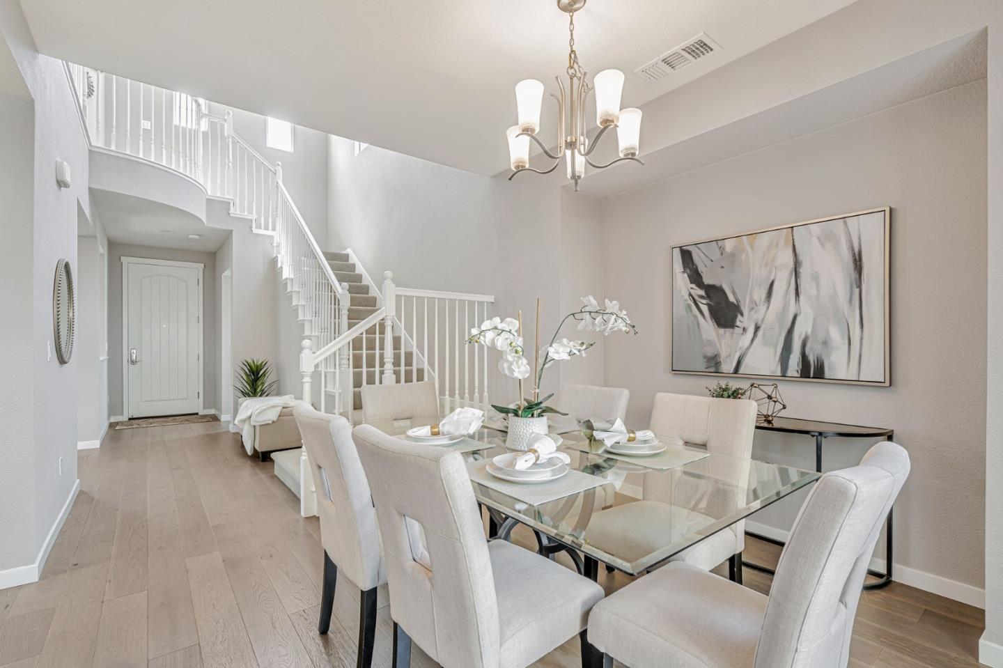310 Villa Street Mountain View, CA 94041 - Photo 19 of 40 a dining room with wooden floor a chandelier a wooden table and chairs