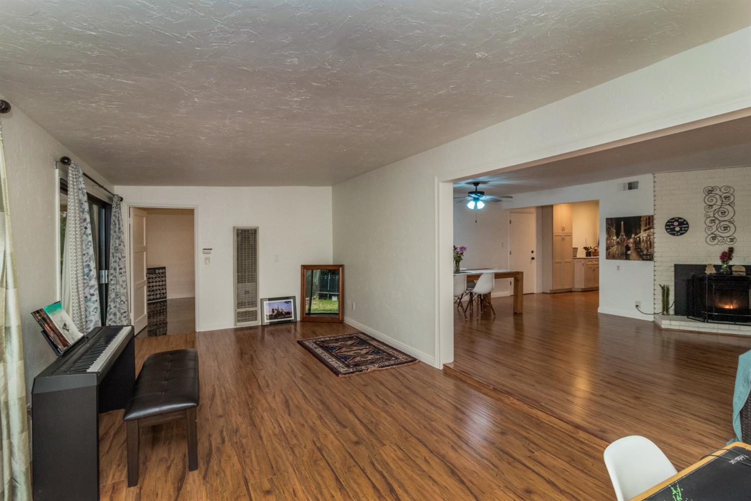 1783 North De Wolf Avenue Clovis, CA 93619 - Photo 11 of 39 a living room with furniture and a wooden floor