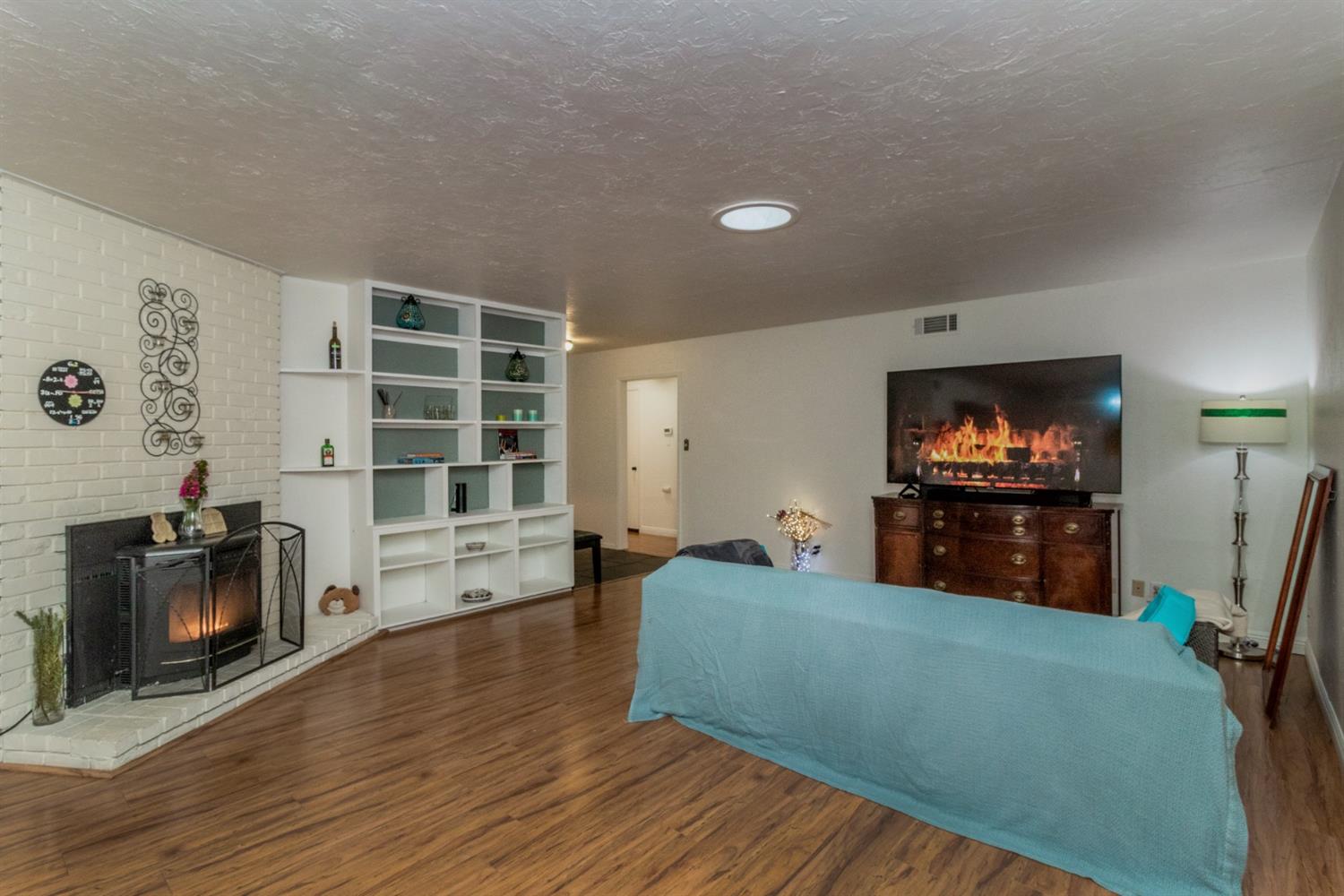 1783 North De Wolf Avenue Clovis, CA 93619 - Photo 12 of 39 a living room with furniture and a flat screen tv