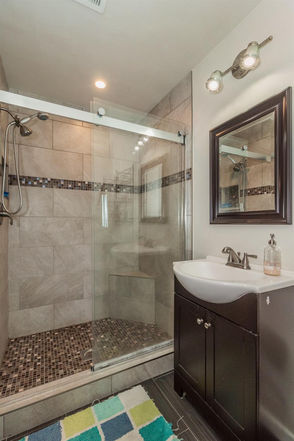 1783 North De Wolf Avenue Clovis, CA 93619 - Photo 17 of 39 a bathroom with a sink and a mirror