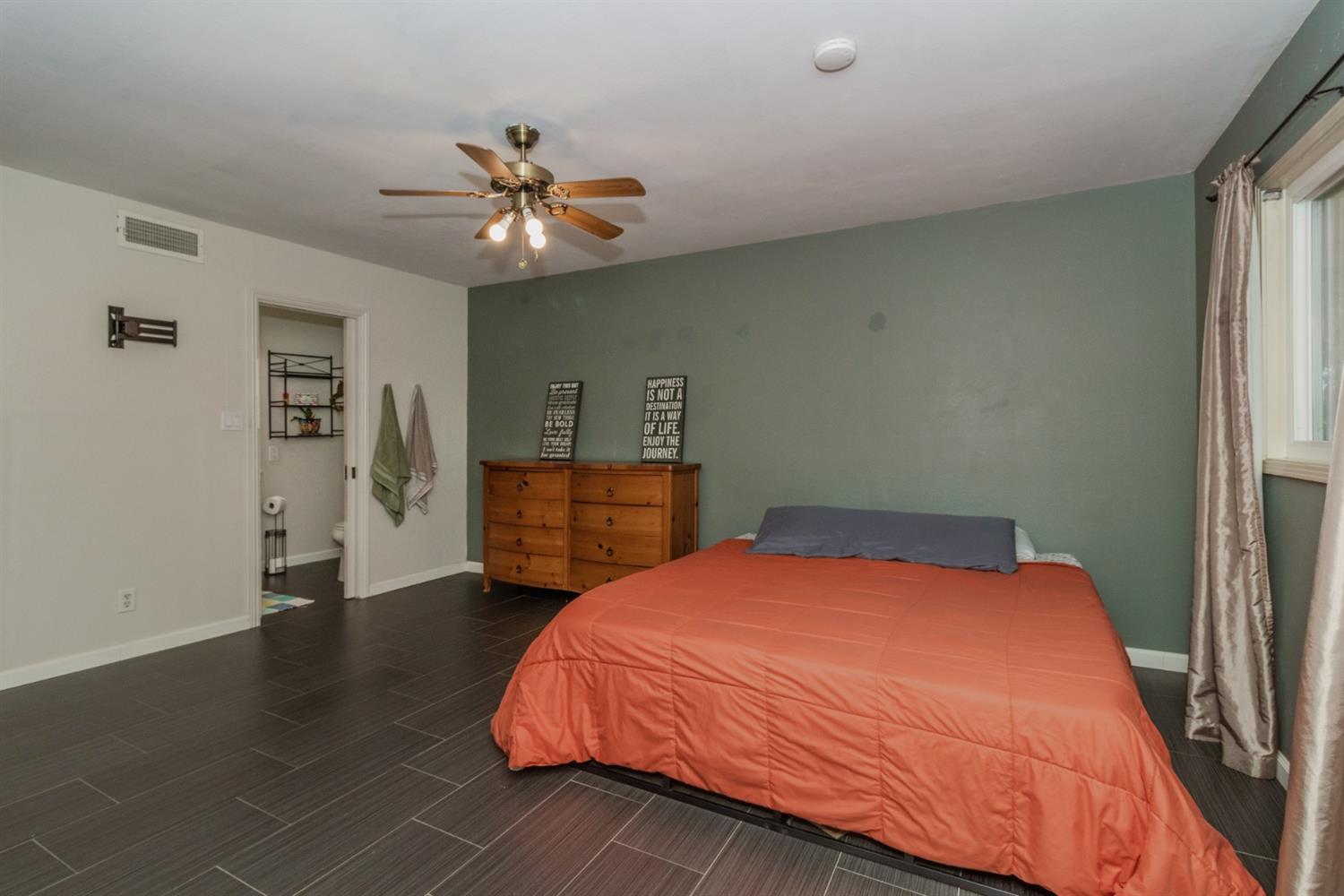 1783 North De Wolf Avenue Clovis, CA 93619 - Photo 18 of 39 a bedroom with a bed and a chandelier