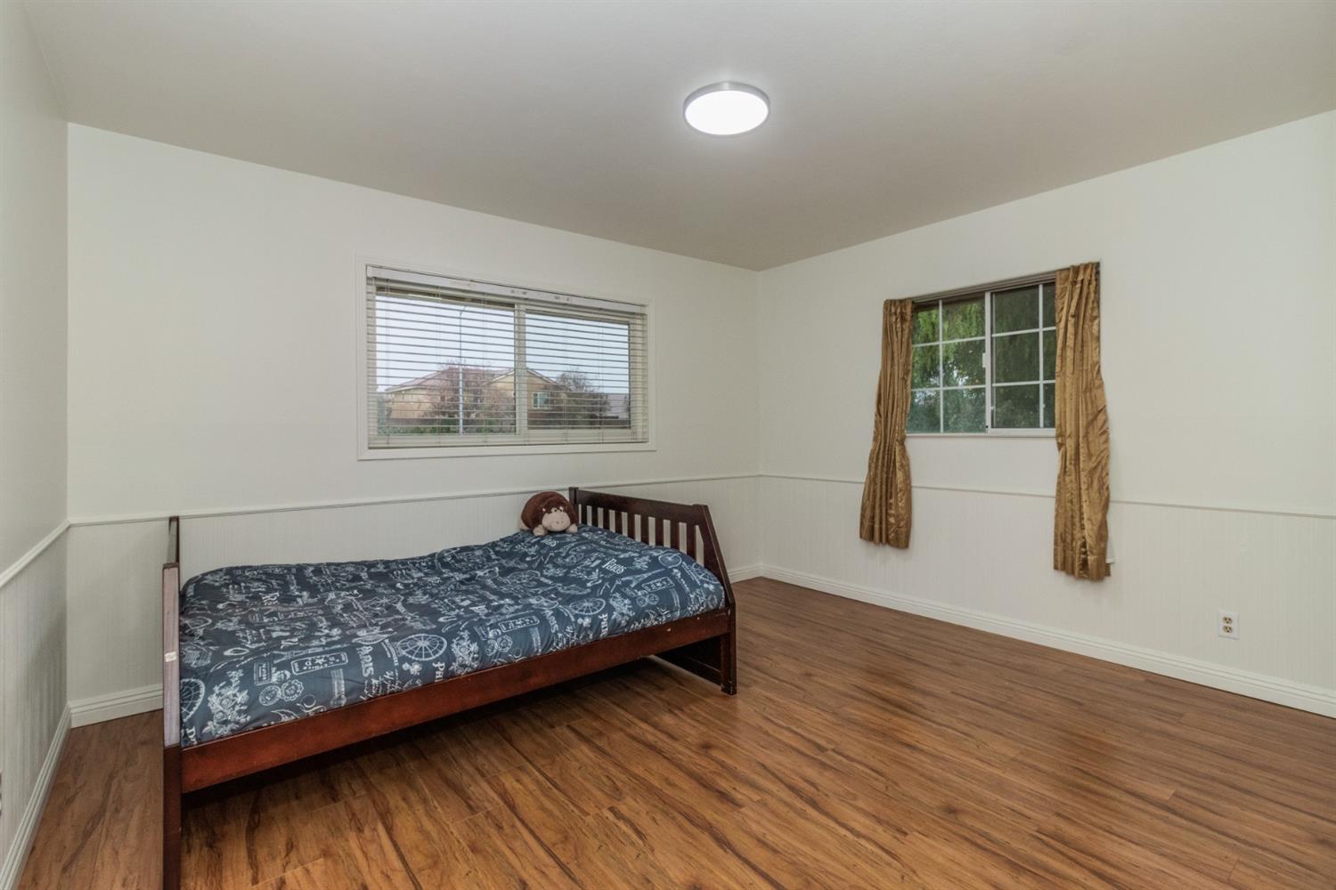 1783 North De Wolf Avenue Clovis, CA 93619 - Photo 19 of 39 a bedroom with a bed and window