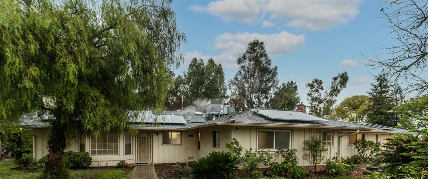 1783 North De Wolf Avenue Clovis, CA 93619 - Photo 2 of 39 a view of a large house with a big yard and large trees