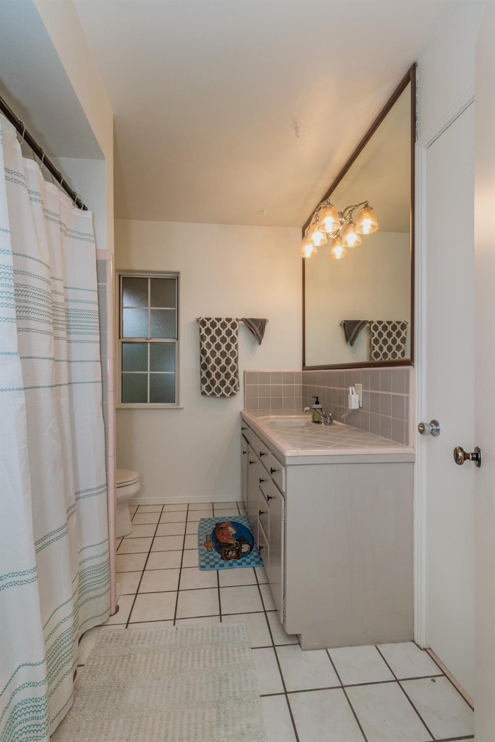 1783 North De Wolf Avenue Clovis, CA 93619 - Photo 23 of 39 a bathroom with a sink and a mirror