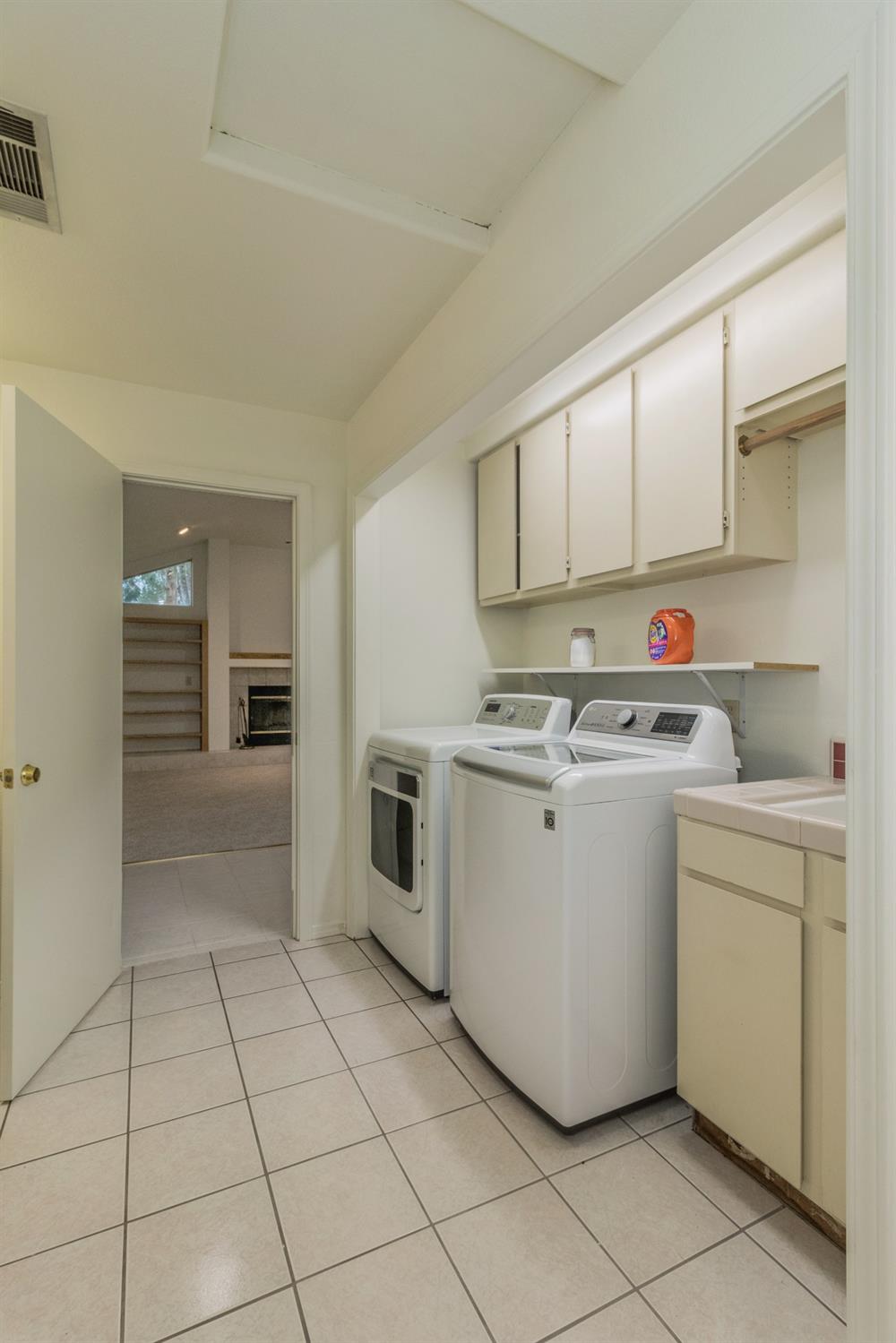 1783 North De Wolf Avenue Clovis, CA 93619 - Photo 24 of 39 a utility room with cabinets washer and dryer