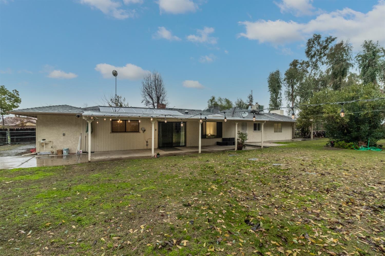 1783 North De Wolf Avenue Clovis, CA 93619 - Photo 29 of 39 a view of a yard with a house and a large tree