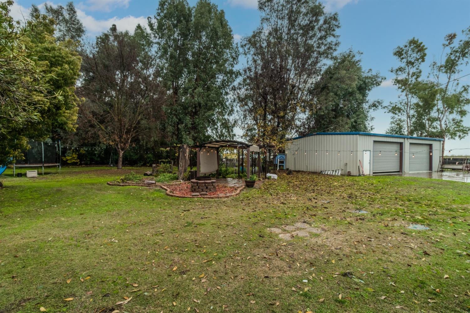 1783 North De Wolf Avenue Clovis, CA 93619 - Photo 32 of 39 a view of a backyard with a garden and trees