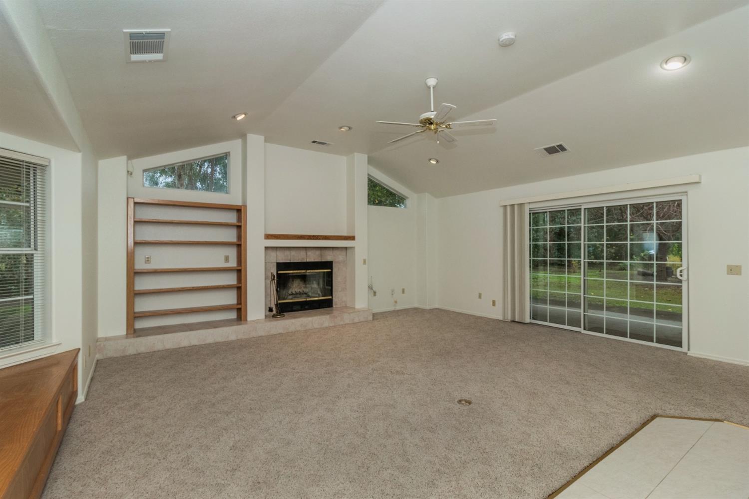1783 North De Wolf Avenue Clovis, CA 93619 - Photo 6 of 39 a view of an empty room with a fireplace and a window