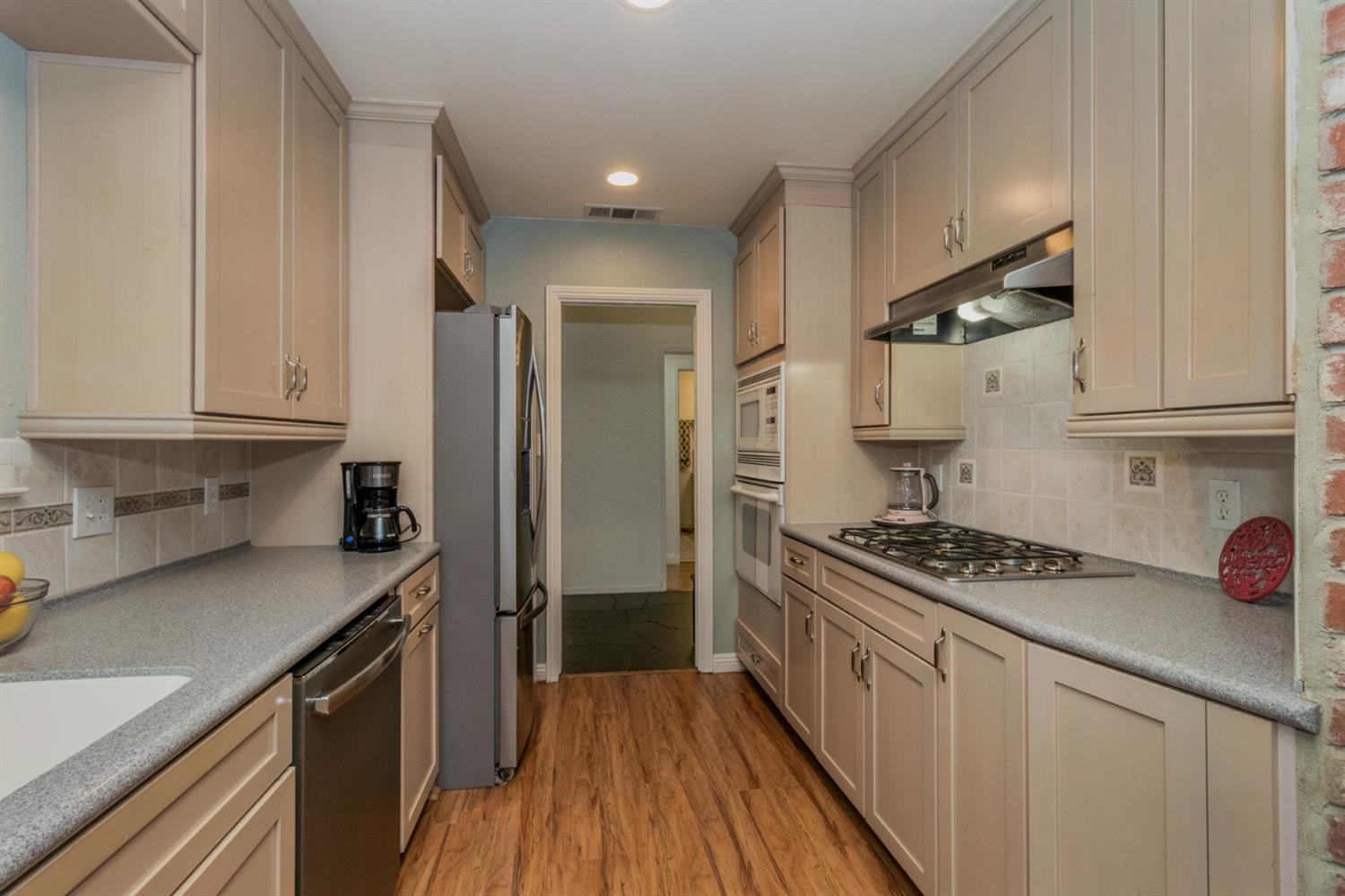 1783 North De Wolf Avenue Clovis, CA 93619 - Photo 8 of 39 a kitchen with stainless steel appliances a sink stove and refrigerator