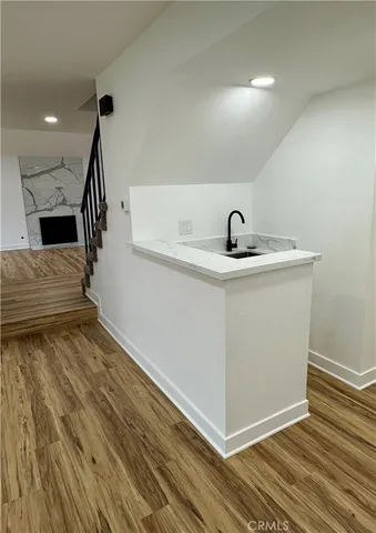 a view of an empty room and wooden floor