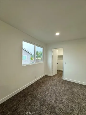 a large bathroom with double vanity sink a two mirror a window and glass door
