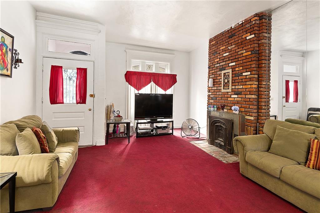 677 Saint Marks Avenue Brooklyn, NY 11216 - Photo 3 of 18 a living room with furniture fireplace and flat screen tv