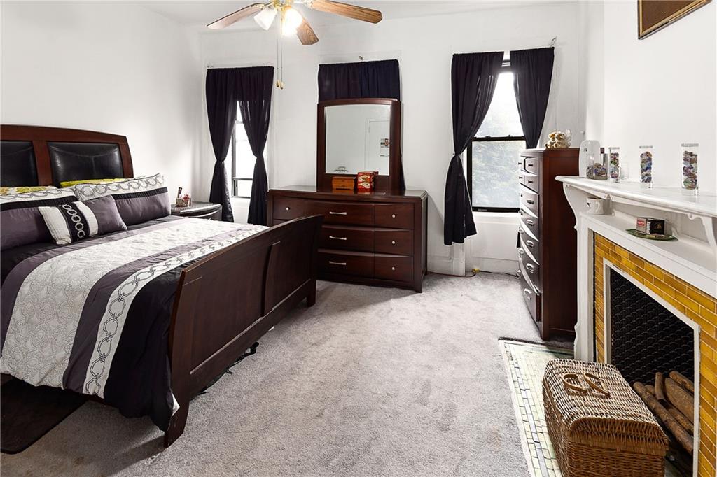 677 Saint Marks Avenue Brooklyn, NY 11216 - Photo 5 of 18 a bedroom with a bed and a mirror