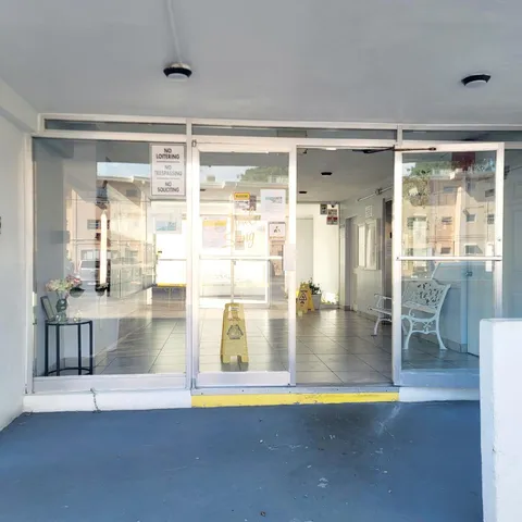 a view of a living room and chandelier with a floor to ceiling window