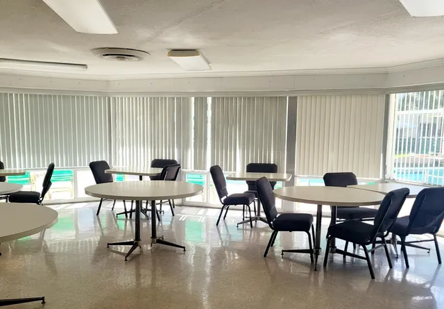a view of a dining room with furniture and window